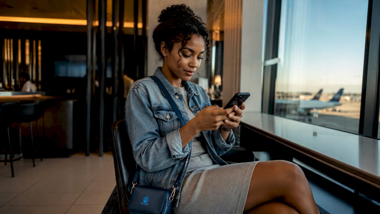 Traveler setting up eSIM in airport lounge