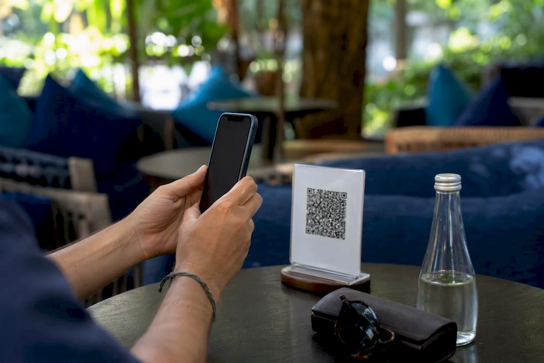 Hands scanning QR code for eSIM setup