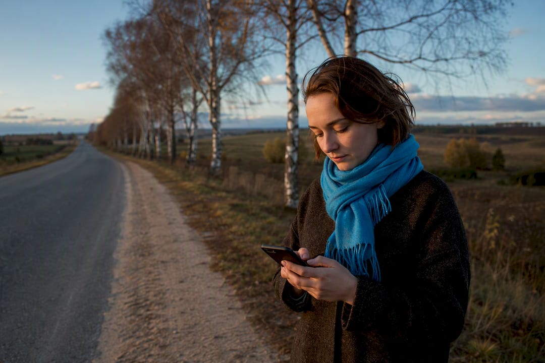 Traveler checking connectivity on rural Belarus road