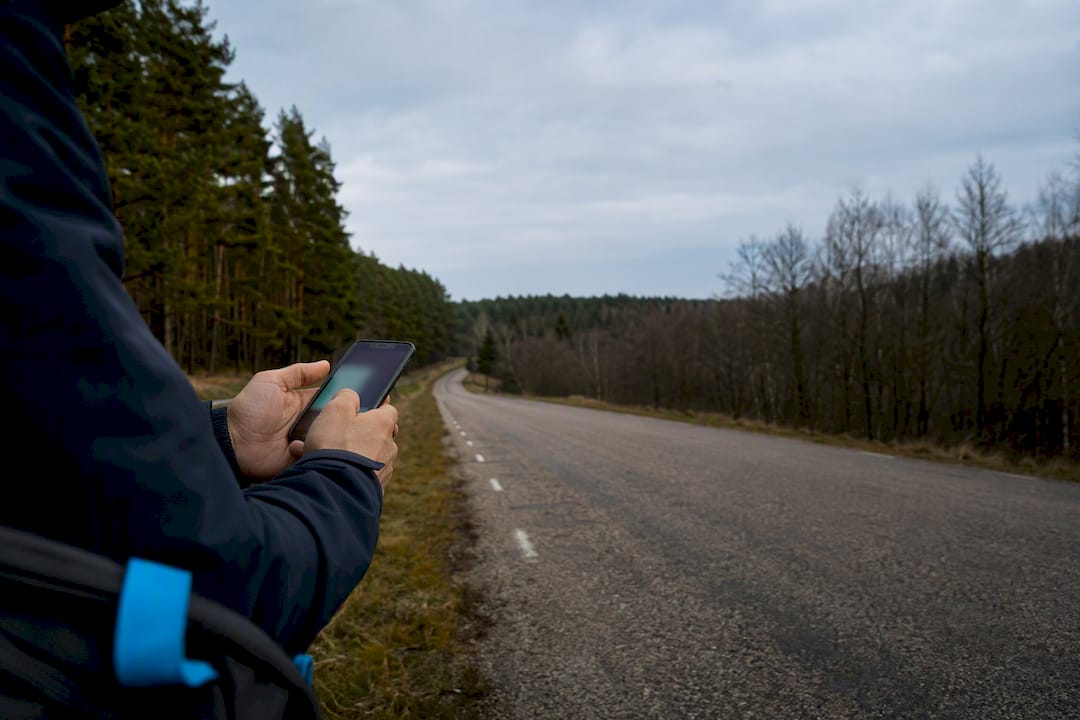 Traveler checking connectivity on a Belarus forest road